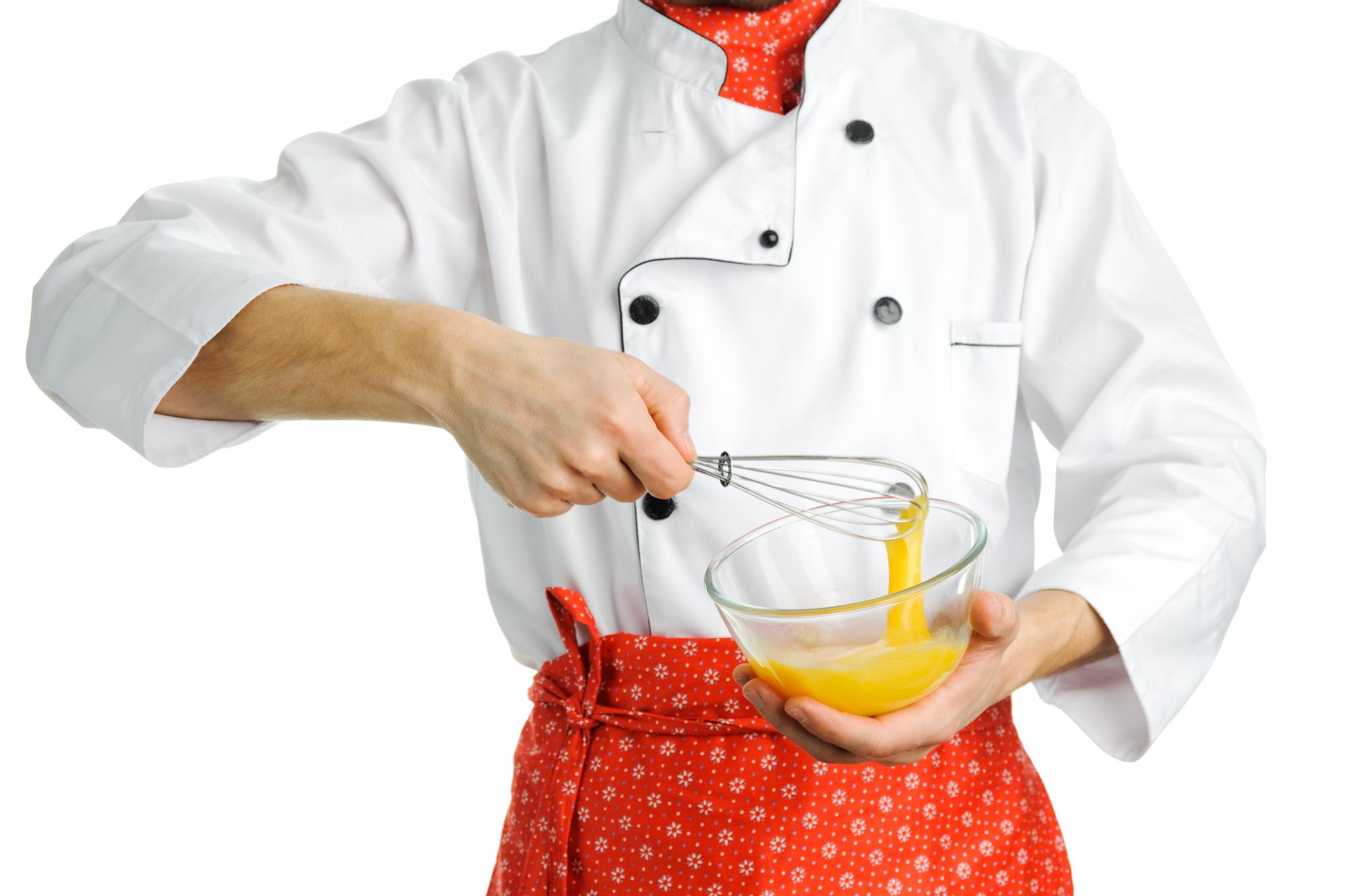 Sous chef demonstrating sauce technique
